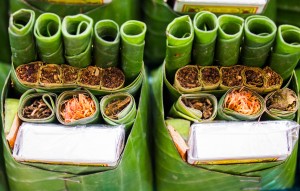 Tobacco and betel nut and betel leaf, Tobacco and betel nut and betel leaf preparing for eat on the old wood, Ripe areca-nut and green betal leaf. Part of Brahman ceremony.